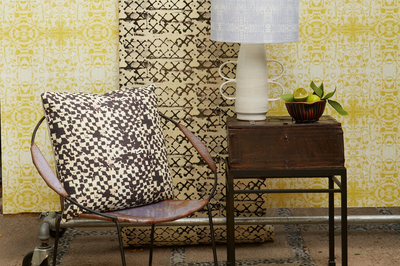 Wallpaper from the Wax collection, Tjanting and Flores Celery, accompanied by a pillow in Tjap and a lampshade in Jamprang lilac.